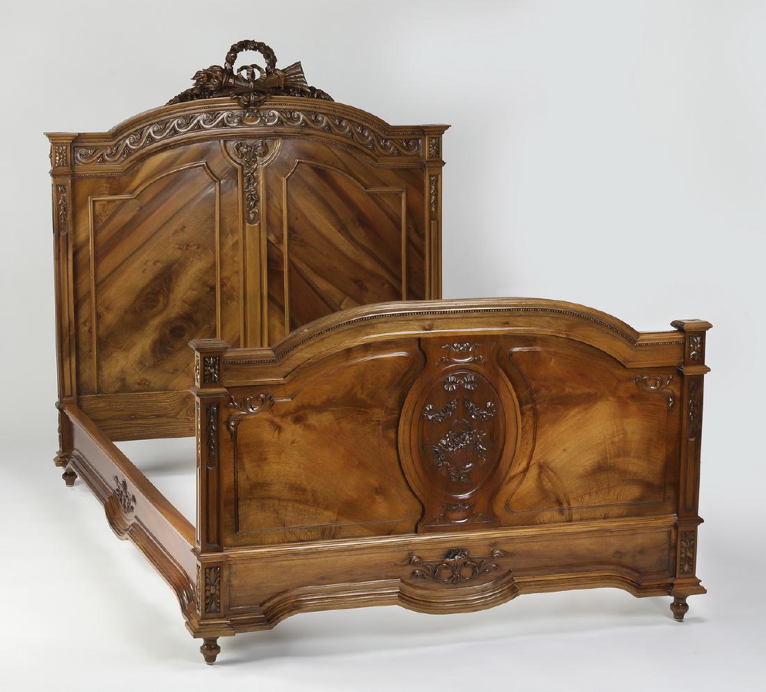 19th c. Neoclassical style French walnut bedstead: French walnut bedstead, 19th century, the headboard having an arched crest topped by a Neoclassical style carved bow and arrow trophy, above a carved meander running frieze and a carved bow with trail