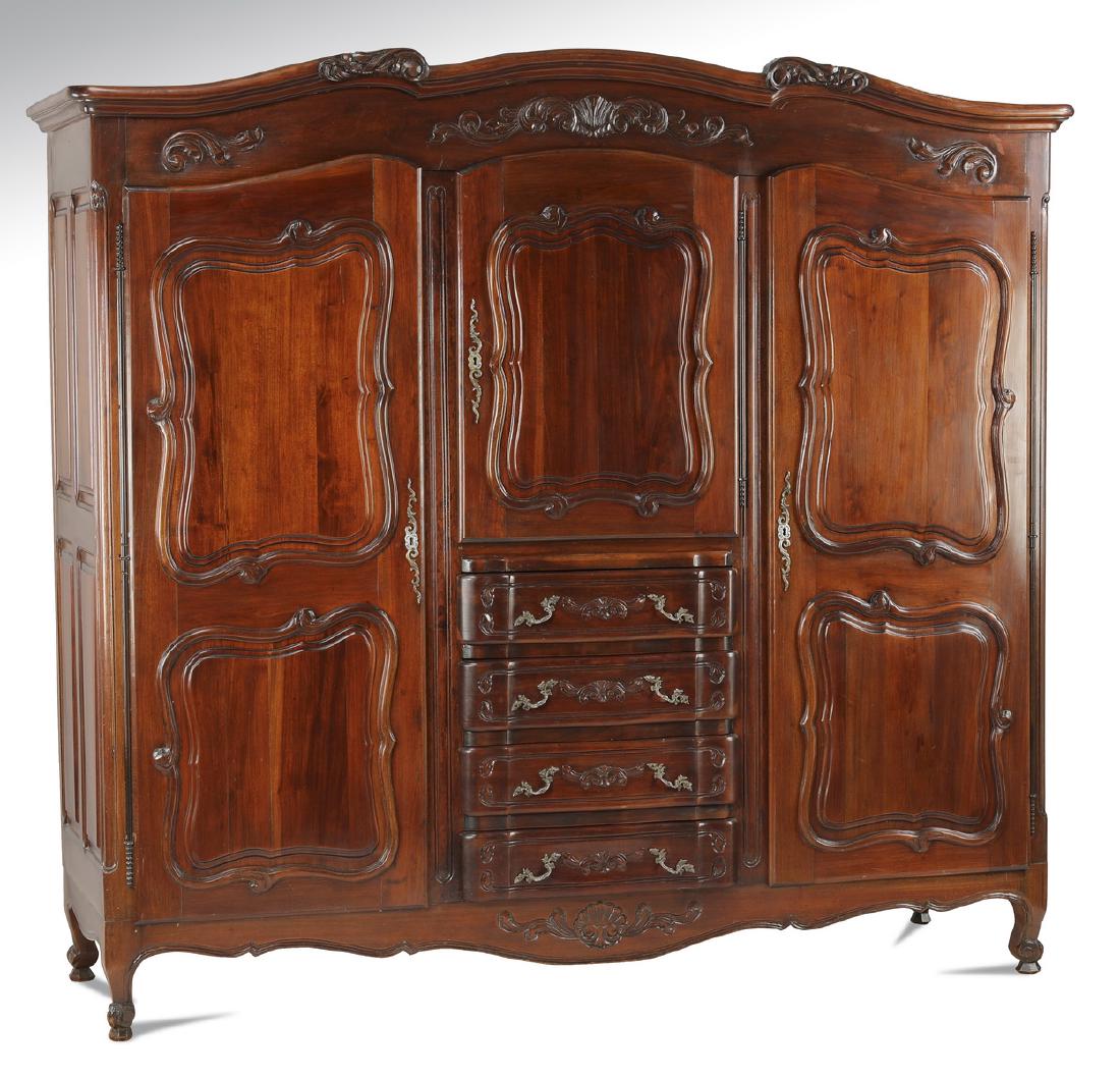 French Provincial style tripartite armoire: French Provincial style tripartite armoire, having a bow-form cornice above a shell carved frieze, surmounting a central half-door opening to one shelf above four drawers, flanked by full doors with m