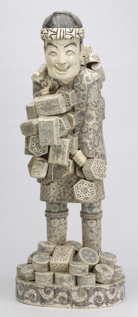 Bone over wood Japanese peddler figure, 33"h: Polychrome bone over wood Japanese peddler figure, depicting a peddler having decorative boxes and Noh masks suspended from a bamboo carrying pole, the whole resting on an oval base, marked to the und