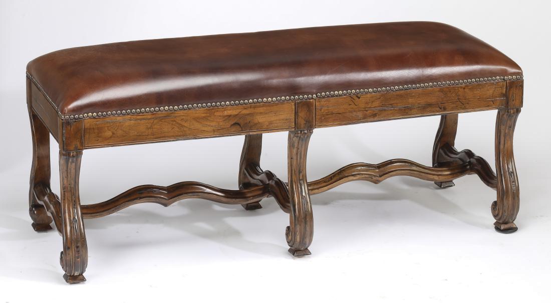 Carved mahogany and leather upholstered bench, 48"w: Carved mahogany and leather bench, having a chocolate leather upholstered seat with nailhead trim resting on S-scroll legs, terminating in spade feet, joined by a scalloped H-form stretcher, 19"h x 48
