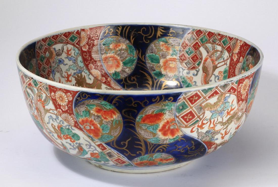 19th c. Japanese Imari porcelain bowl, 16"w: Japanese Imari porcelain bowl, Meiji period, the interior centering a chrysanthemum medallion surrounded by paneled decorations depicting dragons and phoenixes and alternating floral cartouches on a c