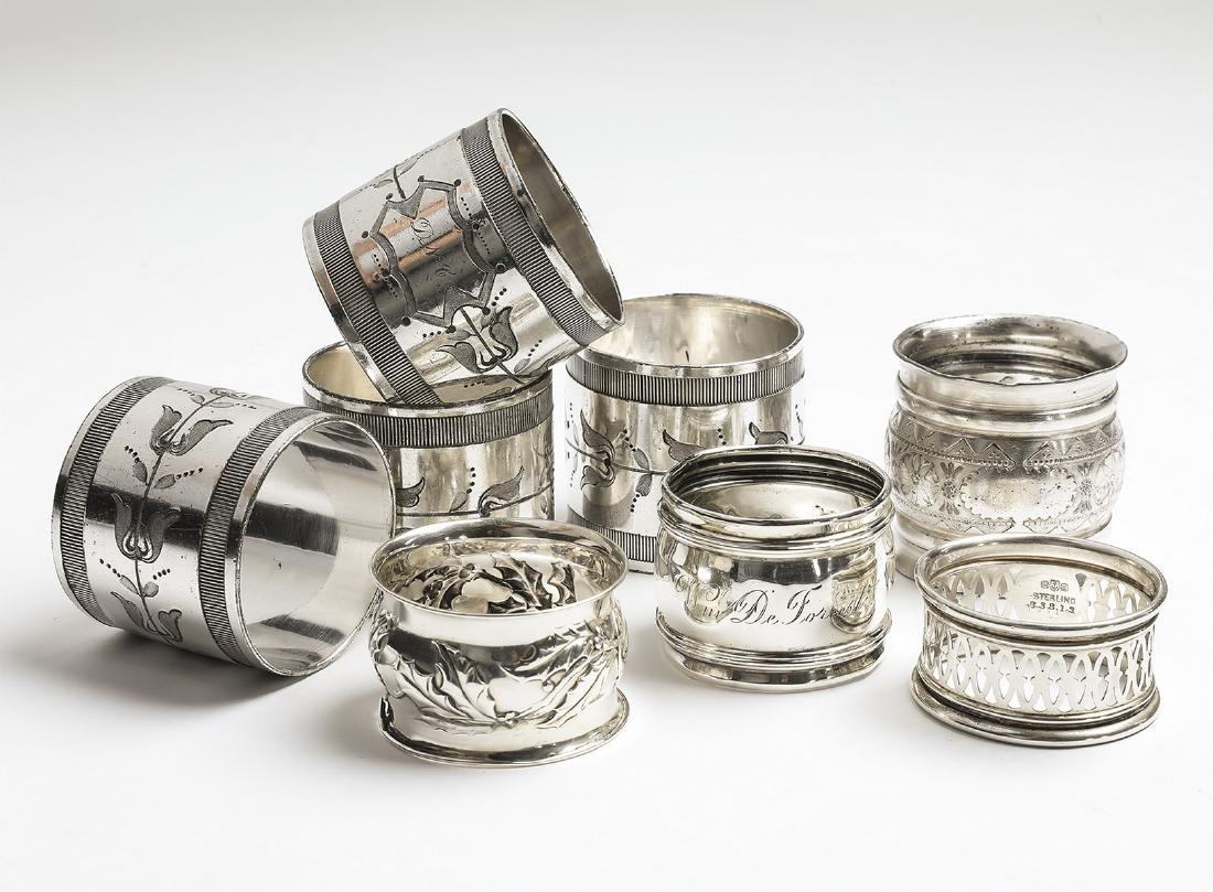 (8) Sterling and silverplate napkin rings: (8) Ssterling and silverplate napkin rings, comprising (3) sterling examples, one by Gorham in a pierced lattice pattern, marked B3813, one engraved 'Wm De Forrest Los Angles 1903, and one with repous