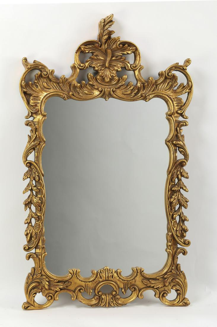 Carved and gilt-decorated Rococo style wall mirror: Carved and gilt-decorated Rococo style wall mirror, having a leaf cartouche centered by highly carved acanthus scrollwork surrounding the mirror glass; mirror 30.5"h x 22.5"w; overall size with frame 