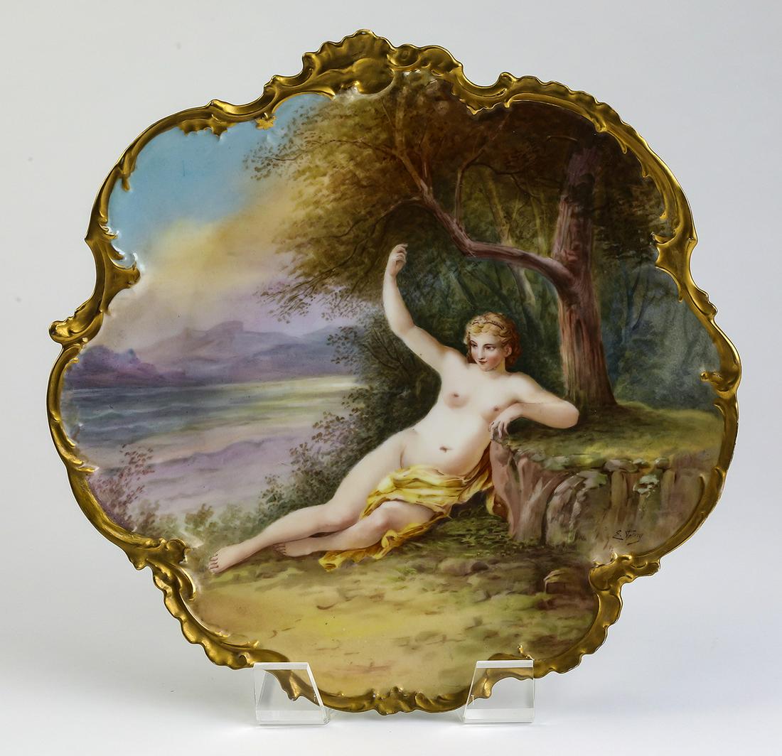 Signed Limoges hand painted charger, 13"dia: Late 19th or early 20th century Limoges hand painted charger, depicting a partially nude maiden reclining under a tree, signed 'E. Valery' at lower right and framed by a heavy gilt Rococo rim, maker m