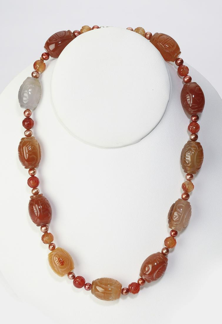 Chinese carved carnelian, agate, & 14k necklace, 18"l: Chinese carved carnelian, agate, and 14k necklace, composed of 21 x 15mm carnelian barrel beads carved with Shou characters and interspaced with 8mm round carved carnelian beads flanked by copper fres
