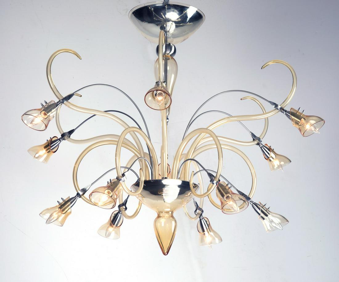 Italian Moderne hand formed glass lily chandelier: Italian Moderne hand formed glass and chrome floral chandelier, having twelve chrome arms ending in stylized citrine glass lily shades, with citrine glass tendrils interspaced throughout and terminati