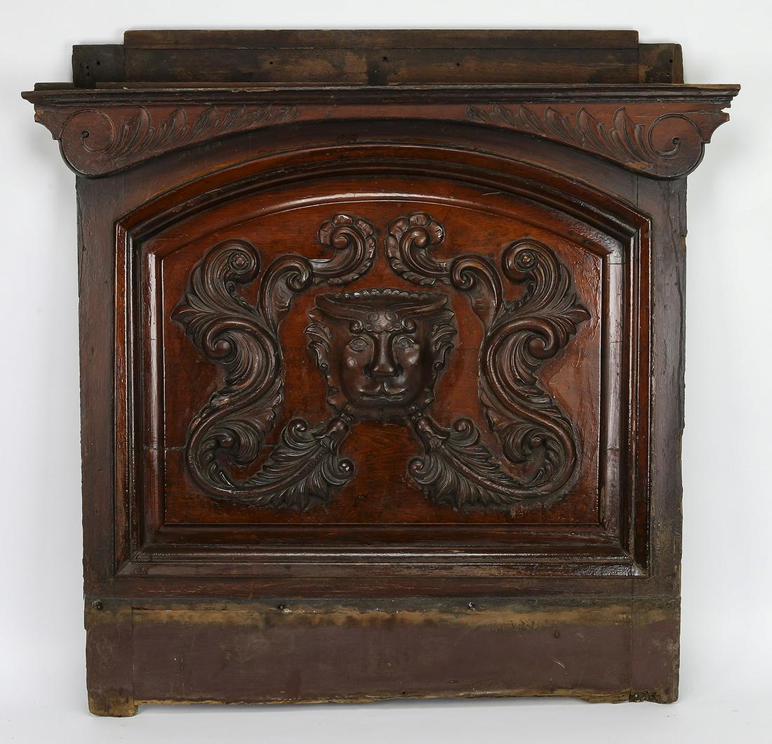 19th c. carved mahogany architectural panel, 44"w: 19th century carved mahogany architectural panel, having a scrolled cornice rising over the arched panel, carved with acanthus scrollwork frame centering a grotesque mask, 43"h x 44.25"w x 4"d.