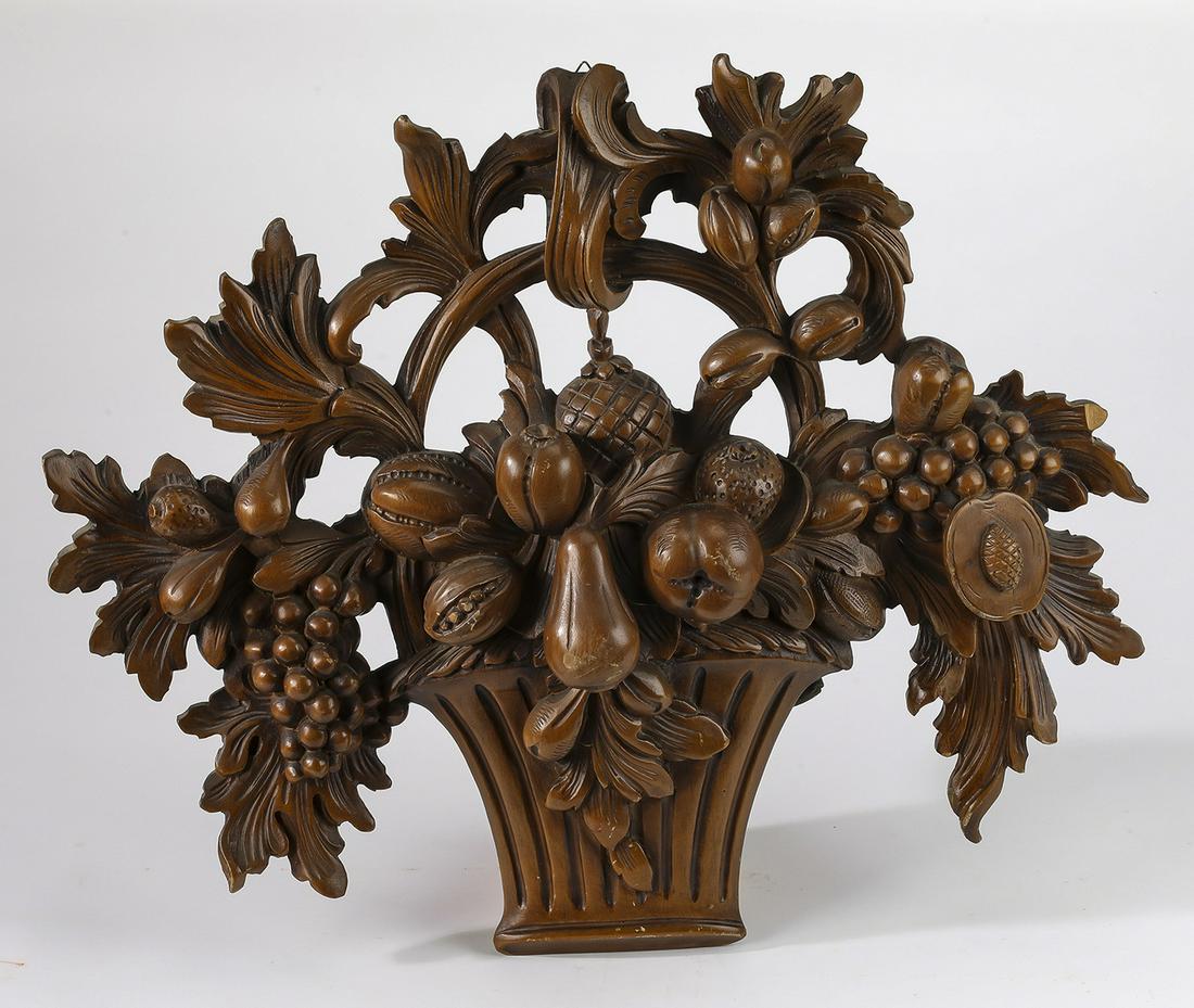 Pierced and relief carved achitectural applique: Pierced and relief carved achitectural applique, in the form of an overflowing basket arrangement of abundant fruits and flowers, 20"h x 24"w x 3"d.