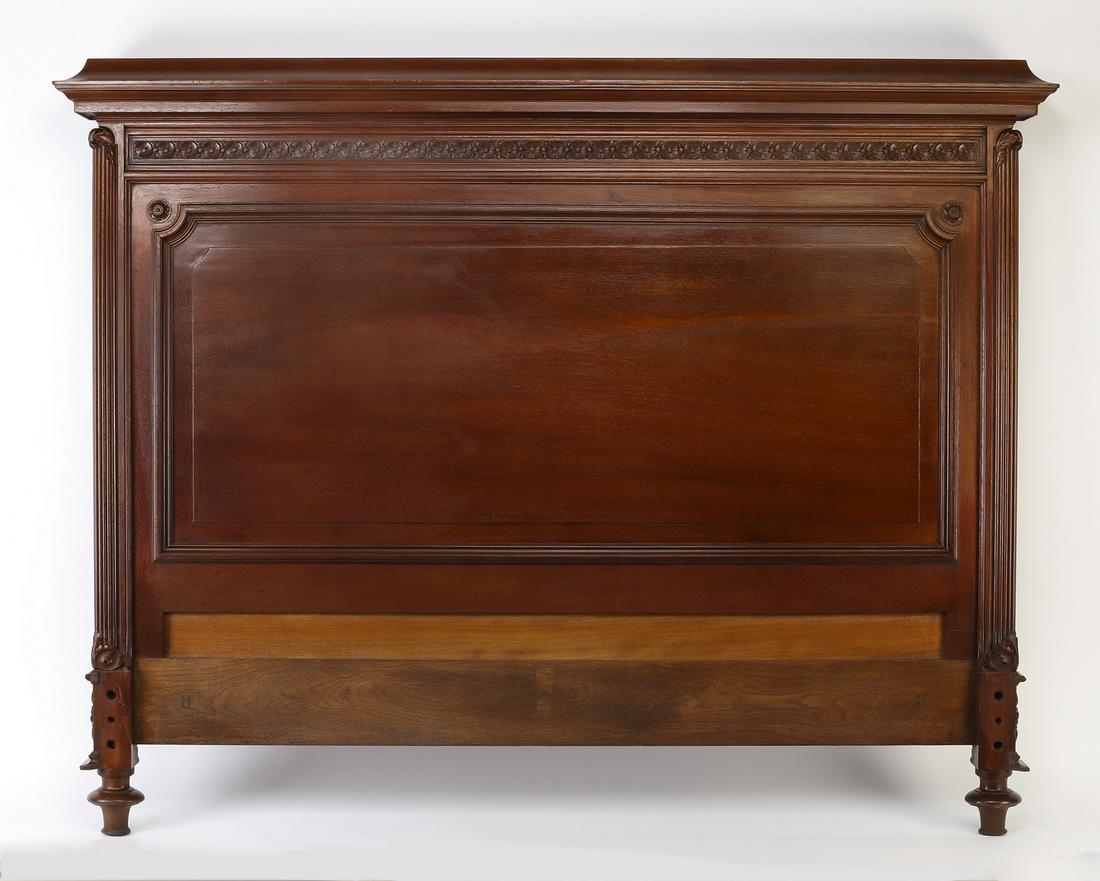 19th c. French walnut full size headboard: French Renaissance Revival walnut full size headboard, late 19th century, having a straight cove molded crest rail above a frieze of flowers, surmounting a panel framed by reeded columns, the whole te