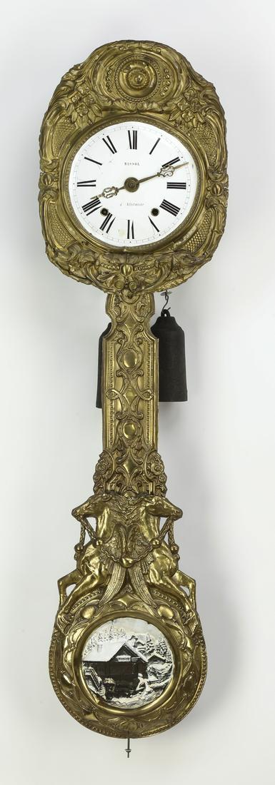 Late 19th c. French morbier clock, 55"l: French morbier clock, late 19th century, having an enamel on metal face with Roman numerals, marked 'Massol a Villefranche,' the dial set in a floral pressed brass surround, suspending a pressed brass