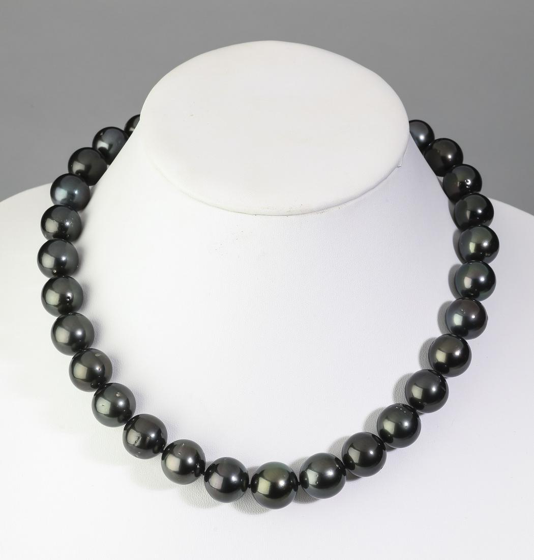 Grey Tahitian pearl and 14k white gold necklace, 18"l: Tahitian pearl and 14k white gold necklace, having 31 grey Tahitian pearls measuring from 13-15mm, hand knotted with a white gold ball clasp, marked 14k, and having an AIG report, 18"l. **Please note 