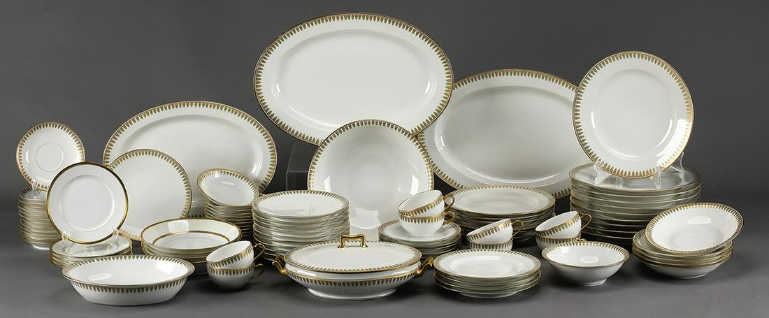 (97pcs) Limoges porcelain table service, ca 1900: Extensive Theodor Haviland Limoges porcelain table service, circa 1900, each piece having an emerald and gilt foliate rim, comprising, (1) dinner plate 10"dia; (6) luncheon plates 8.75"dia; (4) salad 