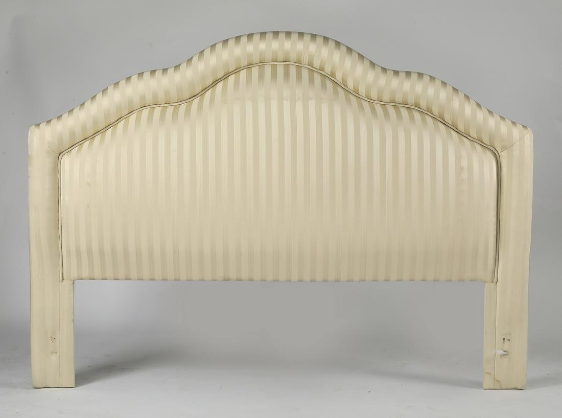 Custom upholstered king size headboard: Custom upholstered king size headboard, having a scalloped crest and upholstered with a white and cream striped fabric, 59"h x 82"w x 4"d.