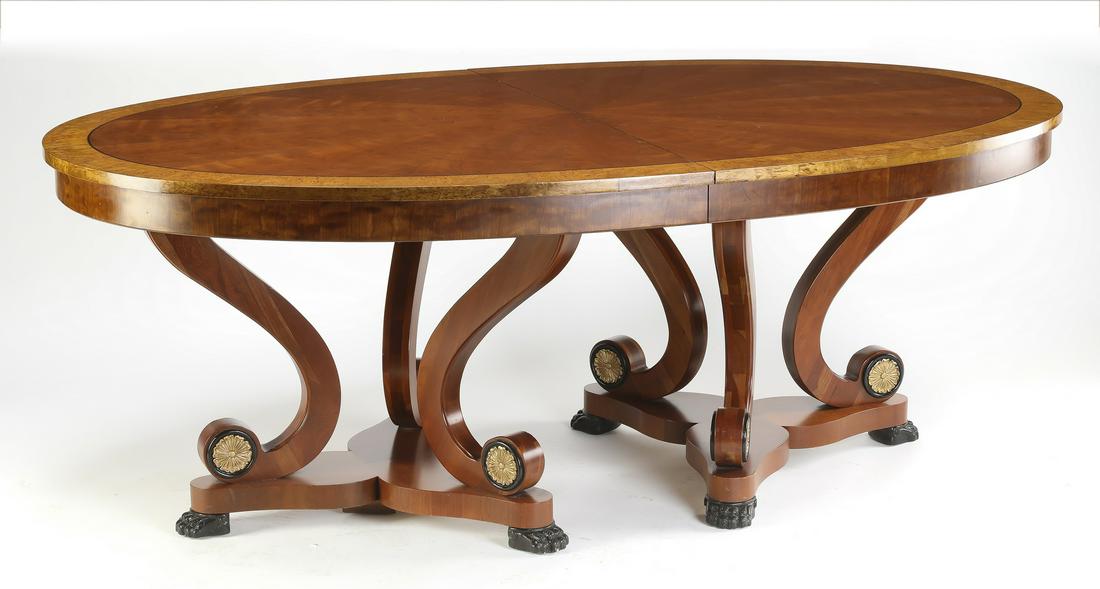 Henredon walnut dining table w/ two leaves: Henredon double pedestal dinning table in the Empire taste, having an oval top with birds eye maple banding and ebony stringing, rising on two pedestals, each with three scrolling legs terminating to