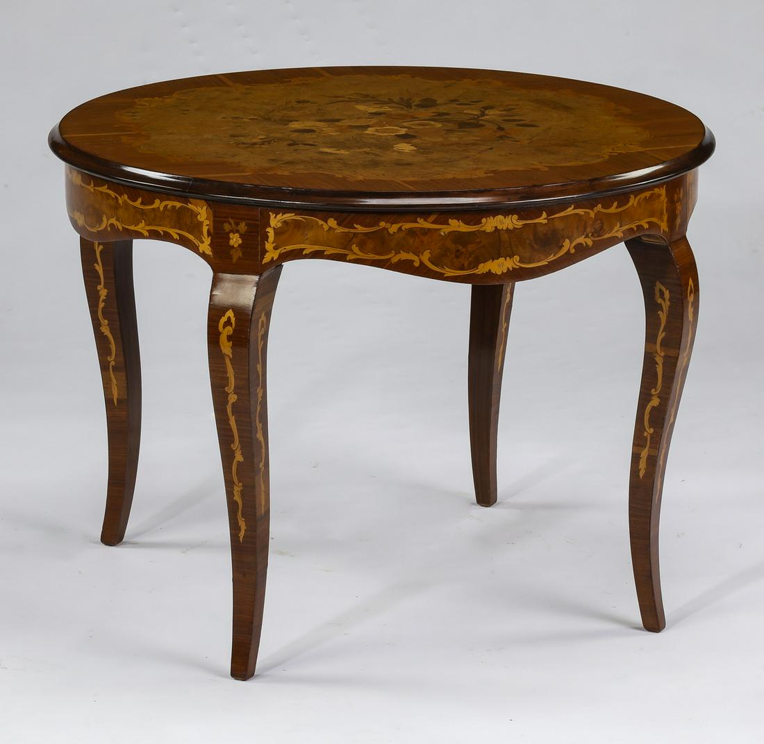 Italian marquetry inlaid accent table: Italian marquetry inlaid accent table, crafted of walnut and maple, having a marquetry inlaid round surface depicting a lush bouquet within a rinceaux frame, rising on an inlaid scalloped apron, termi