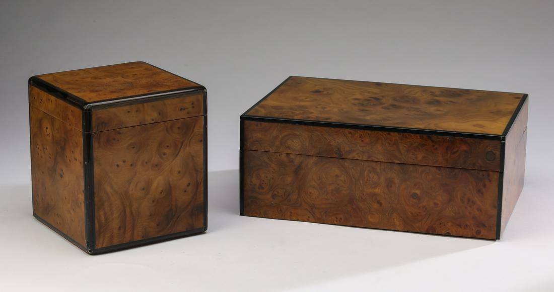 (2) Burl and ebonized wood tobacco accessories: Two burl and ebonized wood tobacco accessories, comprising a square tobacco box, having a hinged lid opening to a brass plaque reading 'Nat Sherman Fifth Avenue New York,' 6.75"h x 6"sq; and a rectang