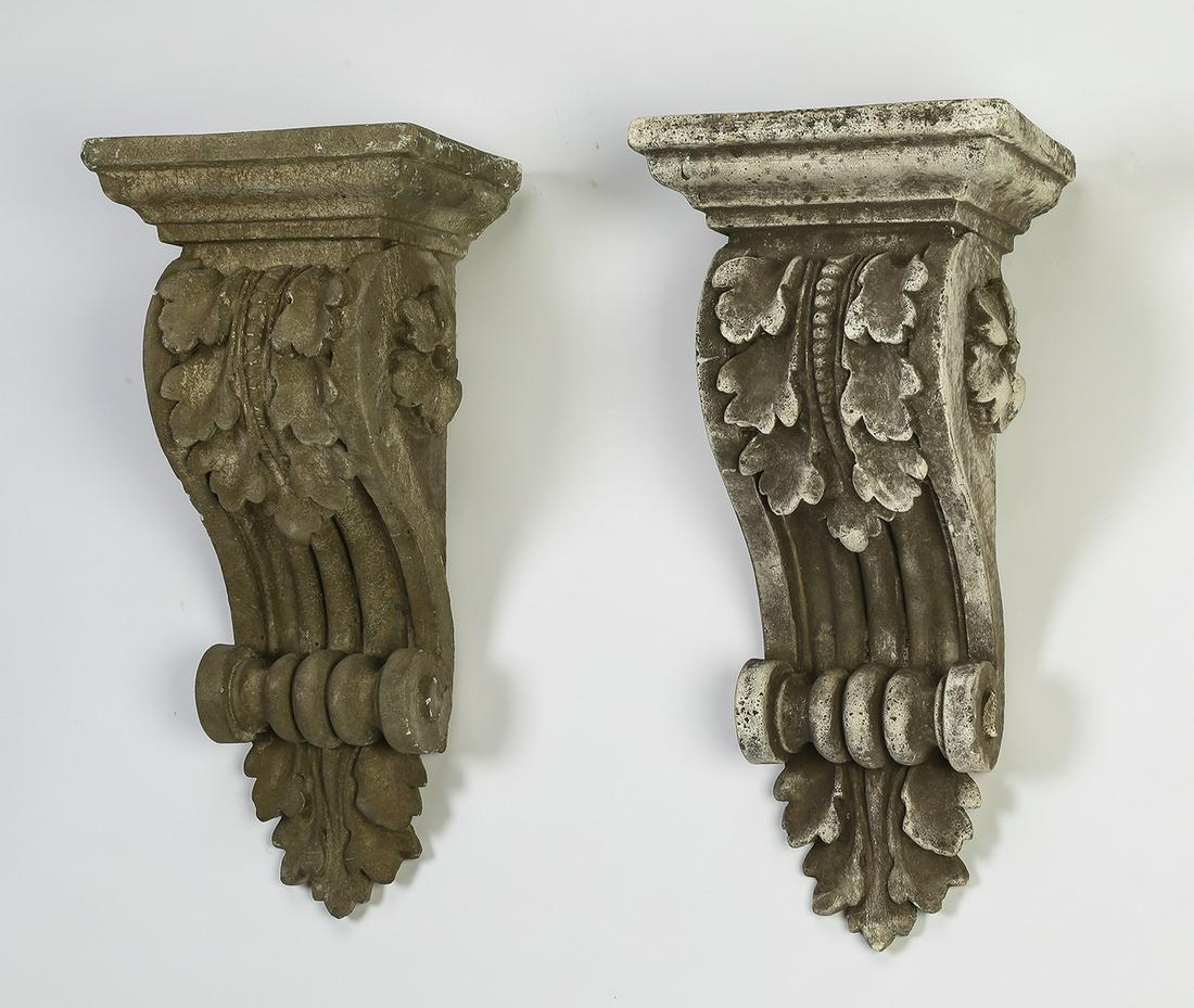 Pair of similar cast stone Classical corbels, 22"h: Pair of similar cast stone corbels in the Classical taste, each having a square top over a molded cornice above acanthus, terminating to a small scroll volute above acanthus pendant, 21.5"h x 13"w x 1