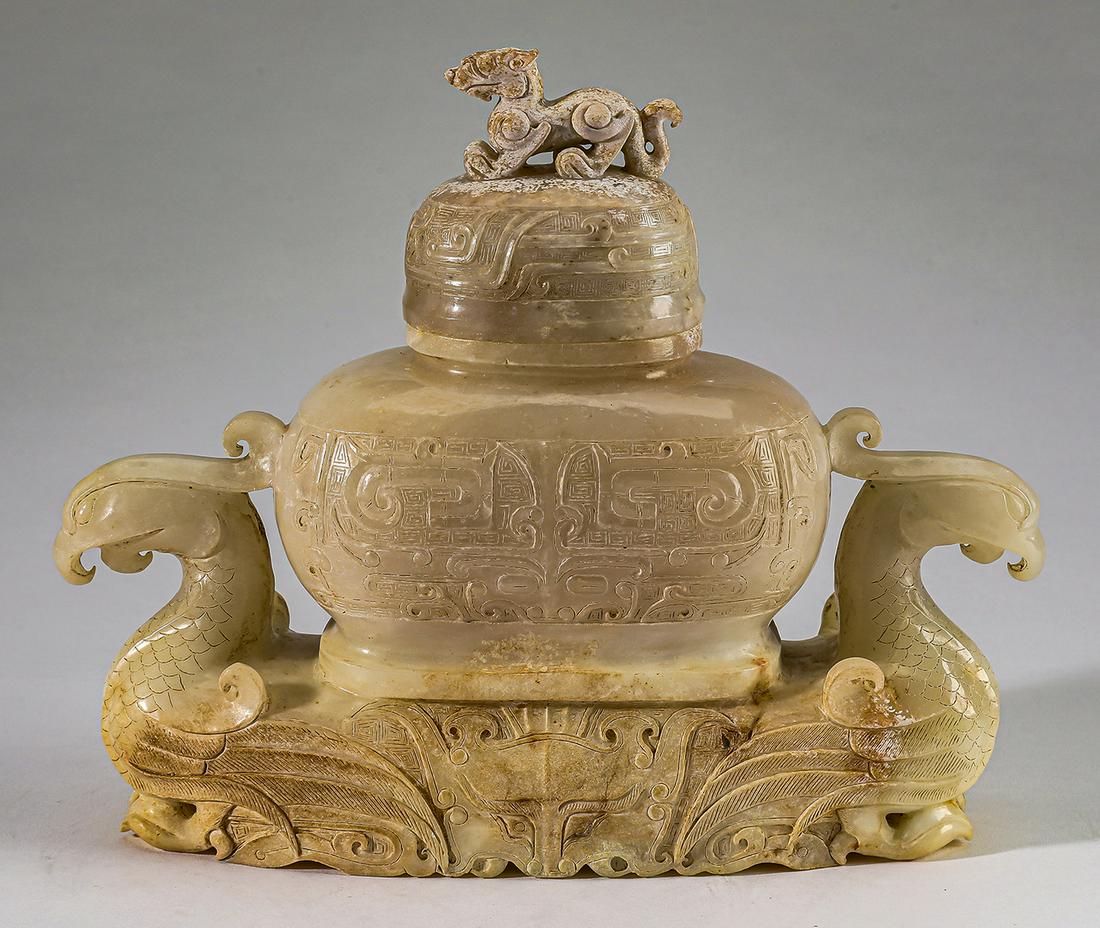 Chinese archaistic style carved jade phoenix vessel: Chinese archaistic style covered phoenix vessel in carved jade, the lid having a Ming dragon finial and Taotie decoration, above a flattened oval form body covered with relief carved Taotie masks, the
