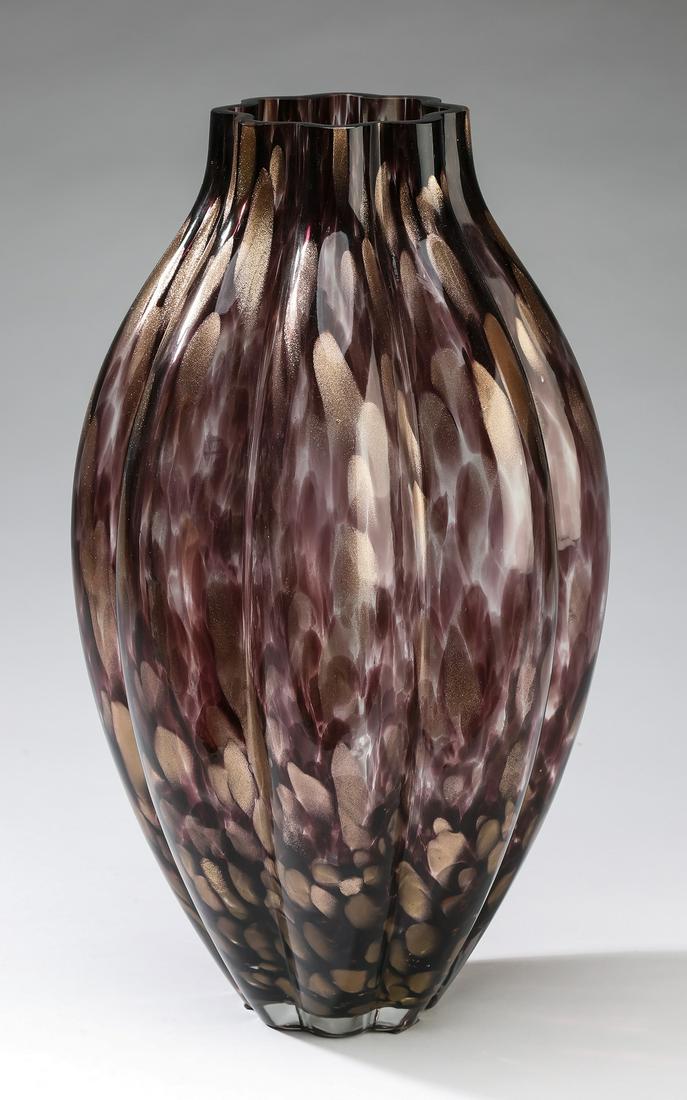 Ribbed mold blown aventurine/amethyst art glass vase: Ribbed mold blown art glass vase, having an elongated ovoid shape with low neck and flat polished rim, colored with amethyst and aventurine frit, 14"h x 9"d.