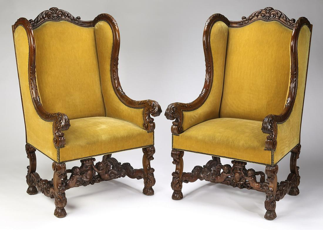 (2) Louis XIII style walnut throne chairs in velvet: Pair of Louis XIII style walnut throne chairs, late 19th or early 20th century, each having an oxbow acanthus carved crest, leading to foliate carved wings ending in acanthus carved terminals, the bac