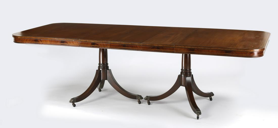 Early 20th c. Sheraton style dining table w/ 3 leaves: Early 20th century Sheraton style mahogany dining table, the rectangular shaped top raised on two tripartite standards with gilt bronze mount animal feet terminating in casters, 29.5"h x 62"l x 44"w;