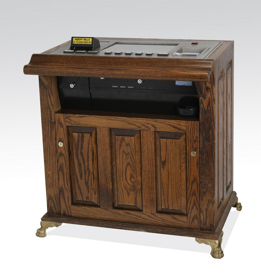 IGT electronic multi-poker machine: IGT electronic multi-poker machine, housed in a vintage style oak cabinet with one door, 33"h x 30"w x 24"d. Condition: Lights up. Overall working condition unknown.