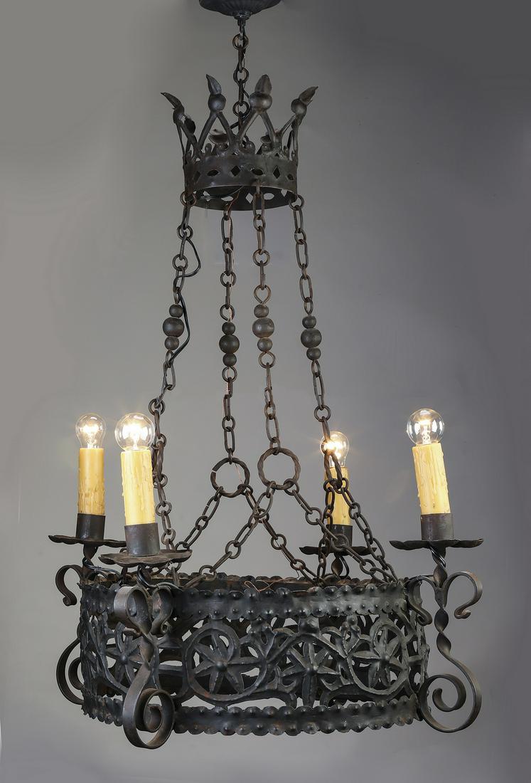 Gothic Revival wrought iron 4-light chandelier: Continental Gothic Revival wrought iron 4-light chandelier, having a pierced circular frame ornamented with stars and foliate scrolls, suspended from a canopy and four chains, issuing four scrolled ar