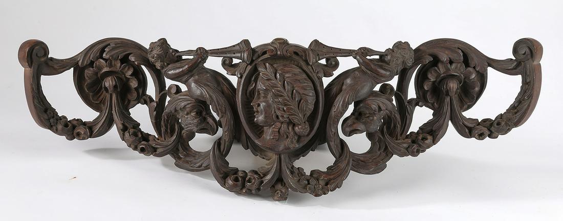 19th c. Empire style carved architectural element: 19th century Empire style pierced and relief carved walnut architectural element, having a maiden's mask in profile on a cartouche flanked by trumpeting putti and eagle's heads, all surrounded by flow