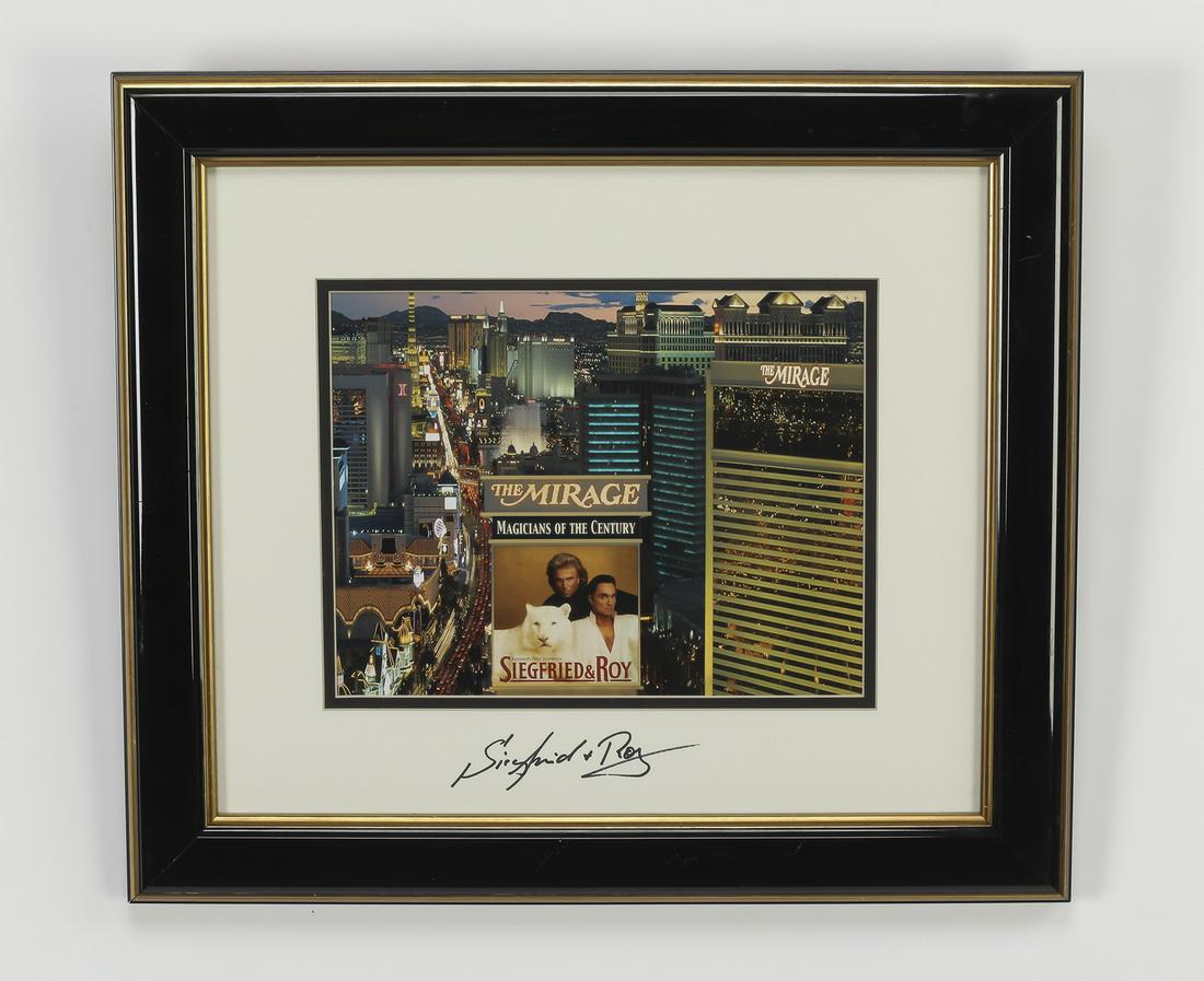 Siegfried and Roy at the Mirage souvenir poster: Siegfried and Roy at the Mirage in Los Vegas souvenir poster with stamped signatures on the matting, in a gilt and ebonized frame, 16.25 x 18.5 x 1.25