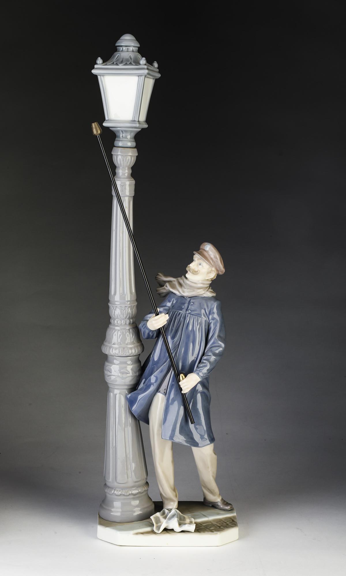 Lladro 'Lamplighter' porcelain figure #5205, 18.5"h: Lladro 'Lamplighter' porcelain figure #5205, designed by Salvador Furi and issued in 1984, depicting a man lighting a street lantern, maker marked to underside, 18.5"h x 5.5"w x 3.5"d.