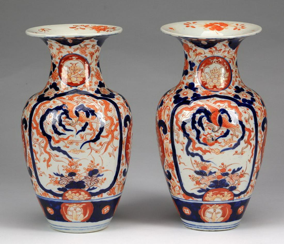 (2) Japanese Imari vases, 19th c., 12"h: Pair of Japanese Imari porcelain vases, late Meiji Period, of baluster form with flared rims and floral cartouches at the neck, the body decorated with polychrome reserves of phoenixes and flowers on 