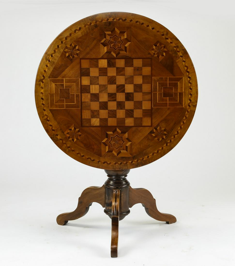 19th c. French satinwood marquetry inlaid games table: French satinwood marquetry inlaid games table, late 19th century, having a circular tilt top surface inlaid with a chessboard, centered by stylized star medallions and a banded border, rising on a tur