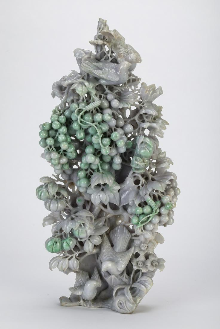 Chinese jade sculpture of birds and grapevines, 17"h: Chinese carved jade sculpture depicting birds perched on grapevines, executed in lavender and celadon jade, having a pair of birds perched atop a grapevine with tendrils and grape clusters above a bra