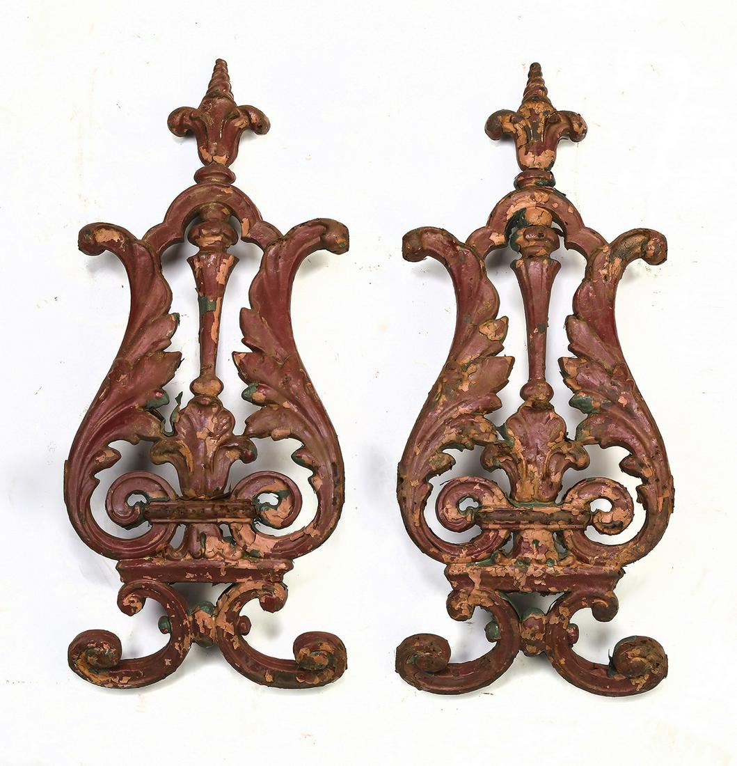 Pair of vintage cast iron architectural elements: Pair of vintage cast iron architectural elements, each with sculptural layers of historic paint-decoration and rich patinated finish, with acanthus scrollwork and tripartite finials, 21"h x 8.5"w x 3"