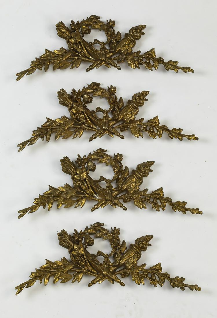 (4) Bronze Neoclassical style appliques, 17"w: Group of (4) bronze Neoclassical style appliques, each having a laurel wreath accented with crossed torches and sheafs of wheat, flanked by vines, 6.5"h x 17"w x 1.5"d.