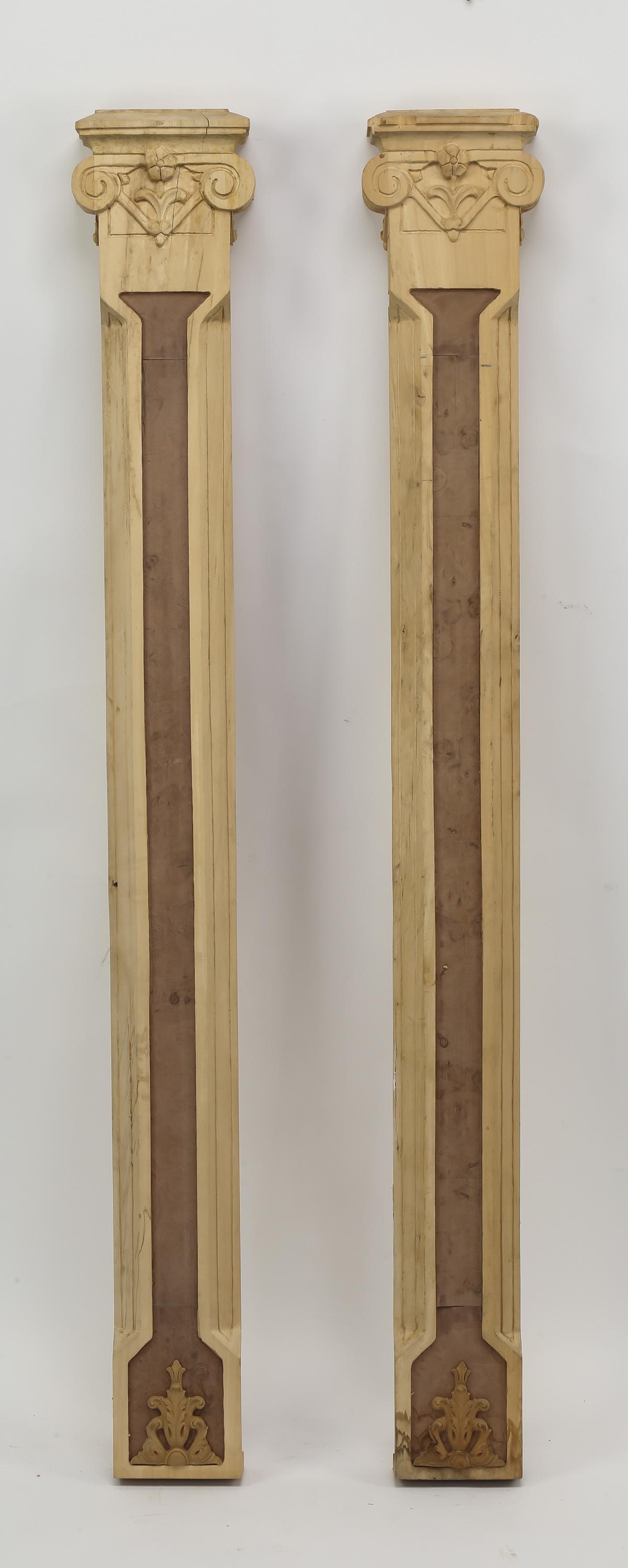 (2) Unfinished carved wood pilasters, 53"h: Pair of unfinished carved wood pilasters, having a shaped cornice, above a scrolling capital, above a standard with an inset veneered panel, terminating to carved scrollwork, 53"h x 7"w x 3"d.