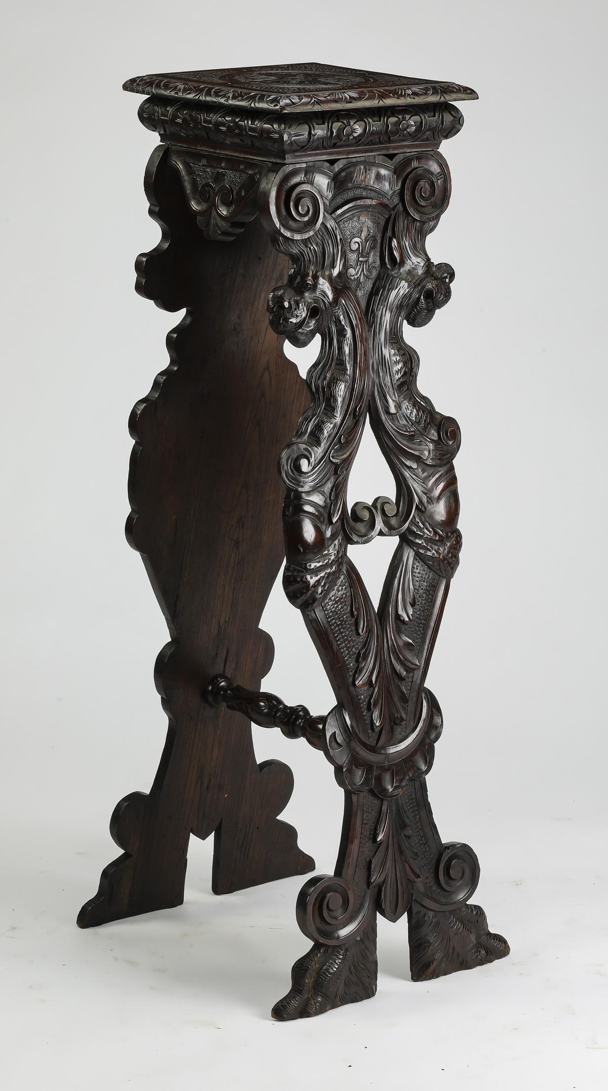 19th c. French Renaissance Revival style walnut stand: French Renaissance Revival style walnut stand, mid 19th century, having a rosette carved surface rising on scrollwork legs carved with figural chimera, ending in hairy paw feet, and connected by a car
