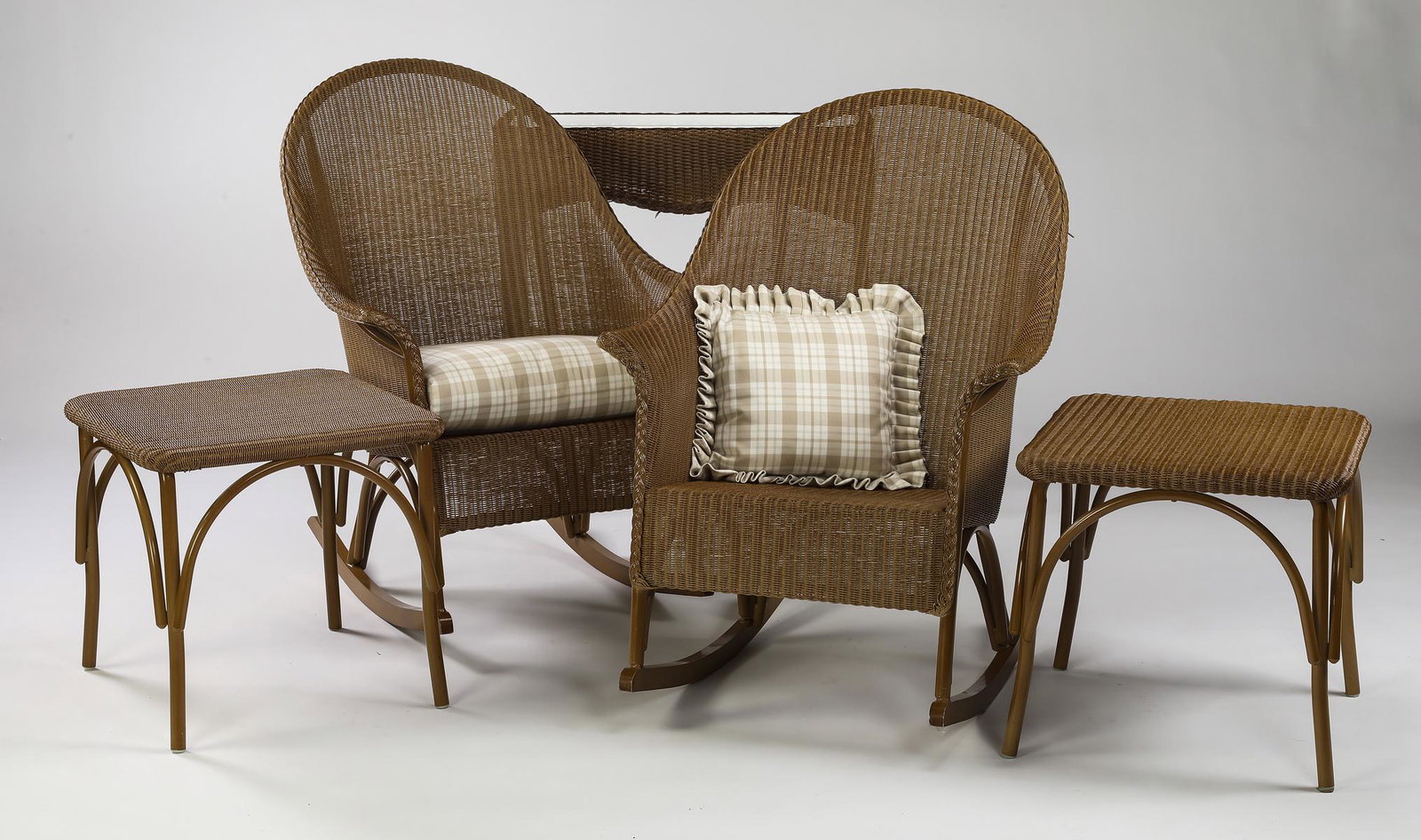 (5) Lloyd Flanders wicker outdoor furniture pieces: Group of (5) Lloyd Flanders wicker outdoor furniture pieces, includes: (1) rocker with a custom seat cushion and (1) rocker with a custom throw pillow, 40"h x 29"w x 31.5"d, seat 19"h, (2) end tables 