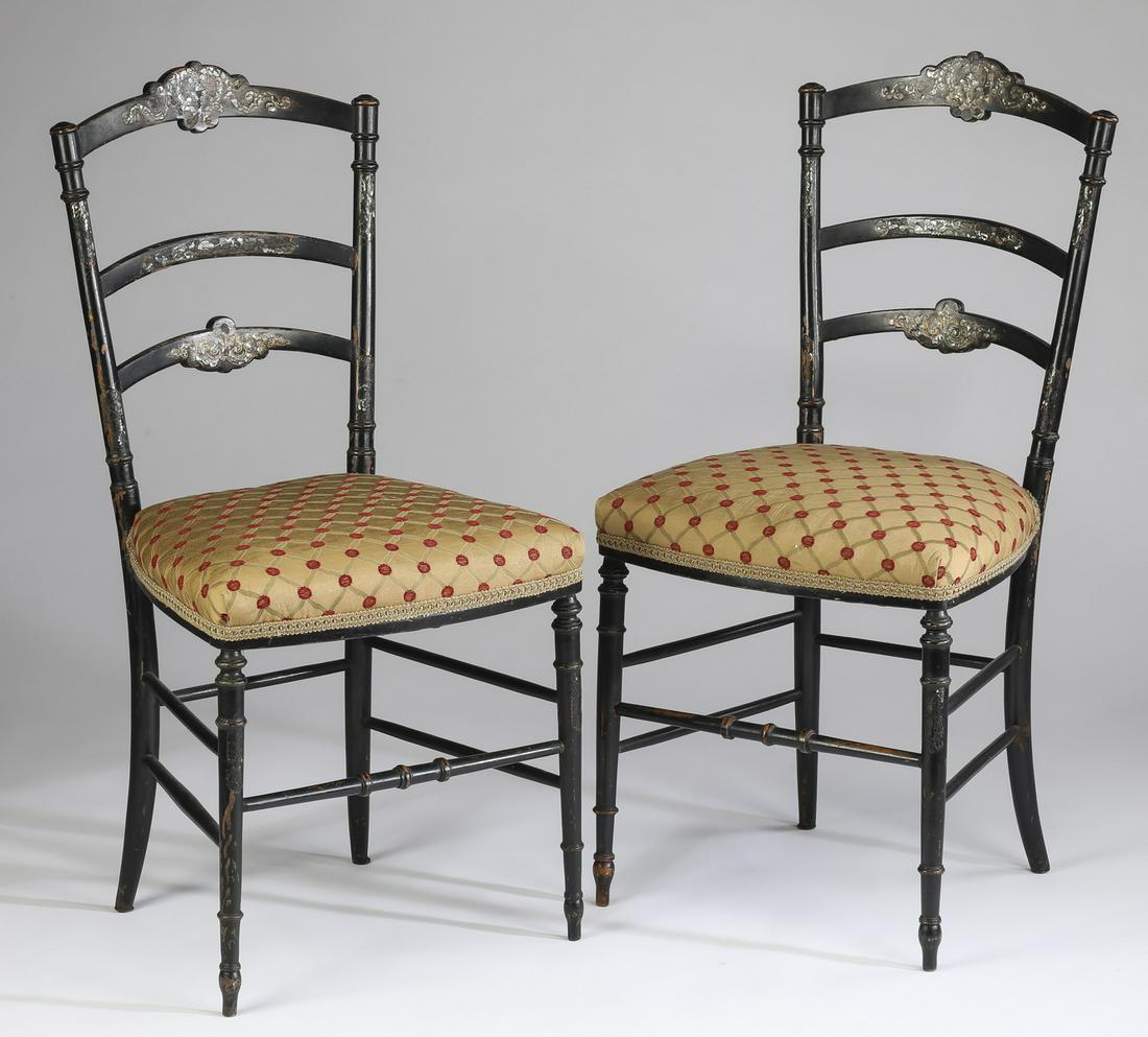 (2) Ebonized side chairs with abalone shell inlay: Pair of side chairs, executed in ebonized wood with abalone shell inlay, each having an arched crest rail with inlaid ribbon design above a pair of slats also inlaid with ribbon motifs, surmounting a