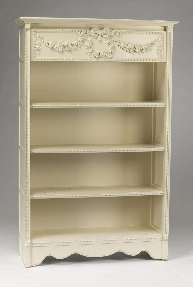 Louis XV style paint-decorated bookcase: Louis XV style paint-decorated bookcase, the cornice above a carved panel with a twist-border centering a ribboned foliate wreath and garlands, above three open shelves, flanked by carved stiles, abov