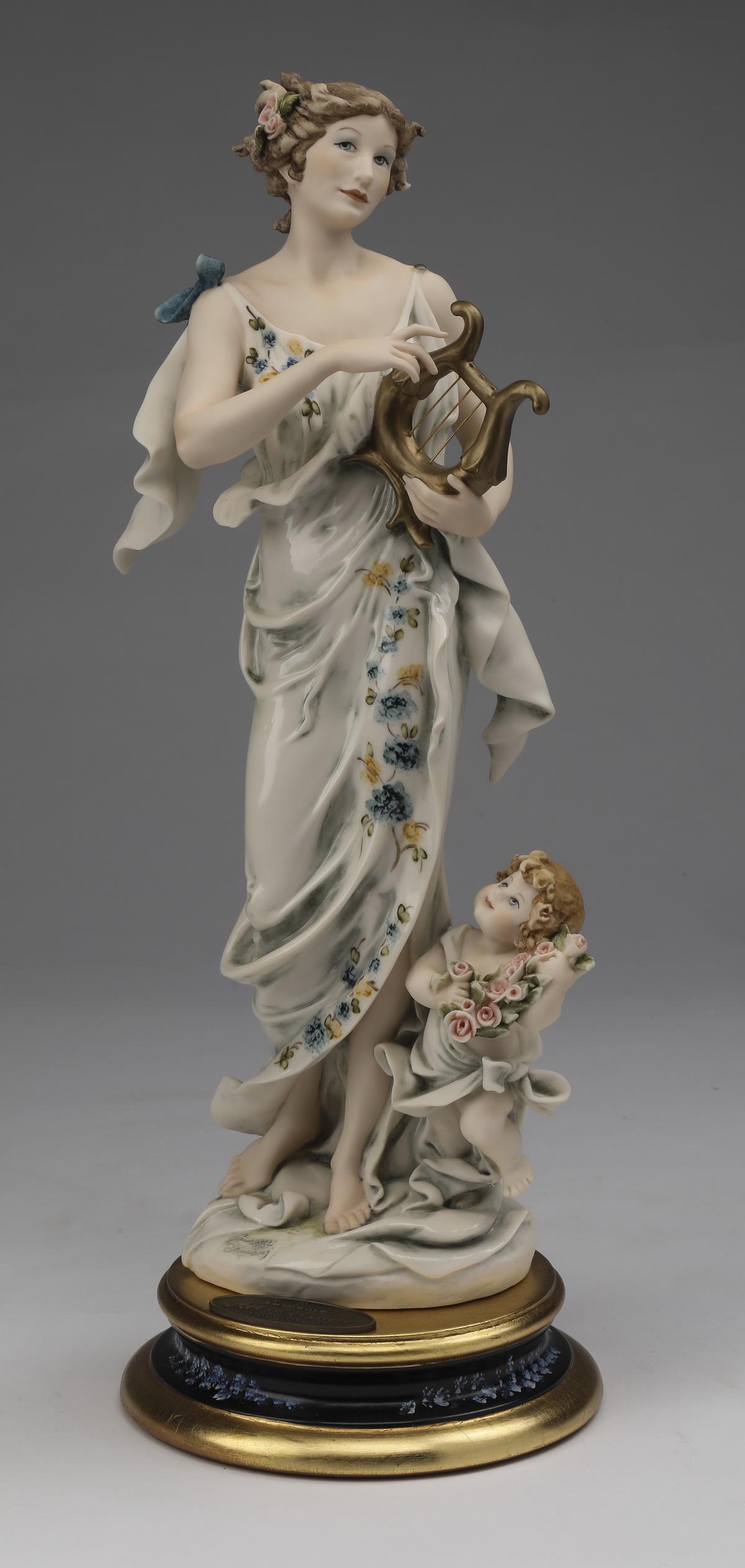 Giuseppe Armani limited edition, 'Art of Music': Giuseppe Armani limited edition art sculpture, 'Art of Music,' executed in composition material with hand painted detail, depicting a nymph playing a harp with a putto, having the Naples mark on the b
