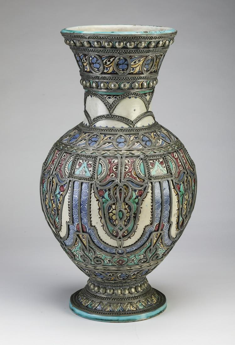 Hand painted Moroccan vase in the Moorish taste, 21"h: Hand painted Moroccan ceramic and metal vase in the Moorish taste, of baluster form, having a trumpet neck above a globular body resting on a circular foot, decorated with geometric and Arabesque desi