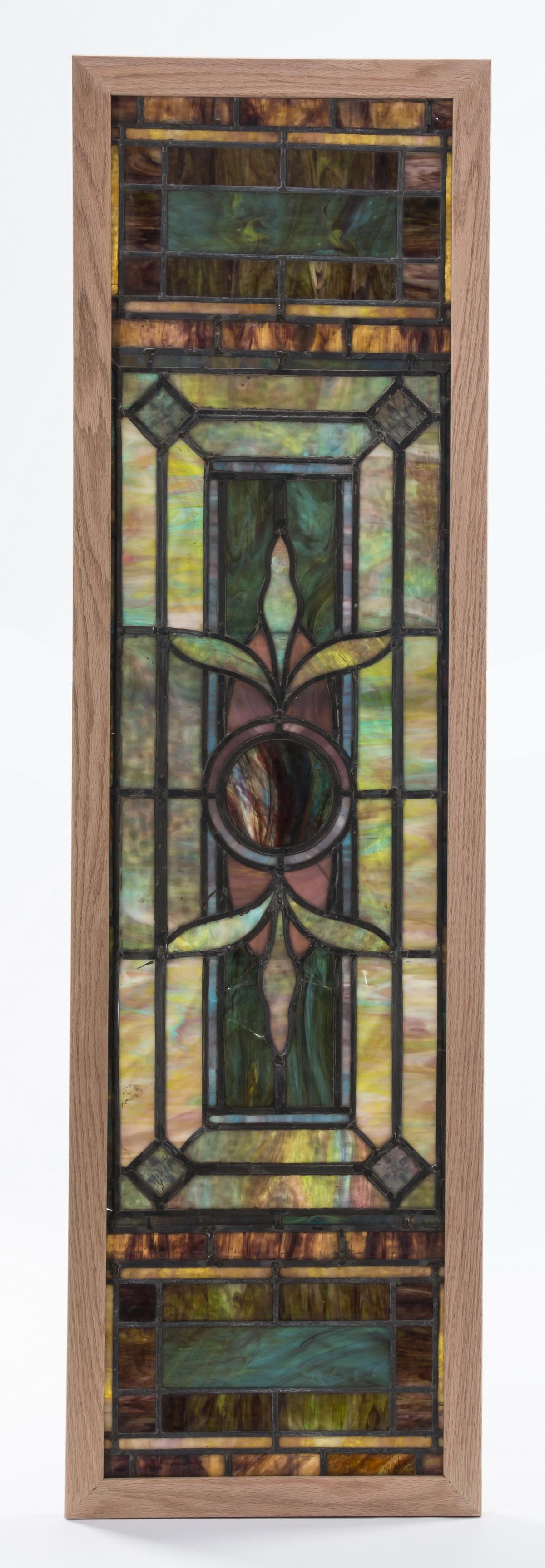 19th c. Ruby Bros slag glass mosaic window, 68"h: 19th century slag glass mosaic window panel, attributed to Rudy Brothers, consisting of a central roundel issuing leaves, framed by geometric shapes in lavender, green, white, and teal, the whole disp