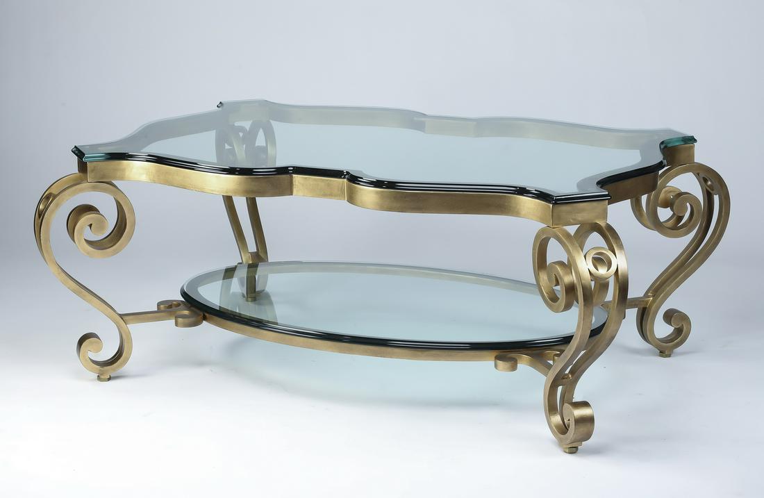LaBarge style bronze and glass coffee table: LaBarge style scalloped two-tier glass and bronze coffee table, having a scalloped glass surface with canted corners above a lower oval glass surface, the whole resting on a gilt bronze base with scro