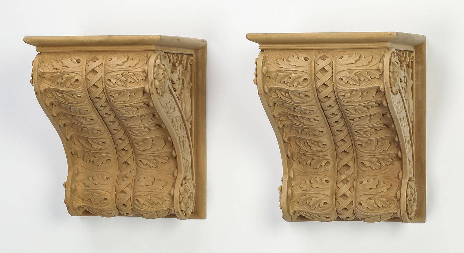 Pair of cast composite architectural brackets, 8"h: Pair of unfinished cast composite architectural brackets, each having S-scrolls with rosettes centering acanthus scrollwork and interlaced ribbons, crafted of cast composite material, 8"h x 8.5"w x 11