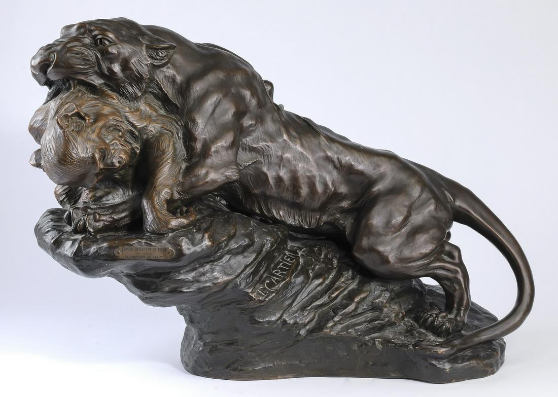 Thomas F. Cartier signed terracotta sculpture: Thomas Francois Cartier (French, 1879-1943), paint-decorated terracotta sculpture titled 'Lionne Emportant Sa Proie' or 'Lioness Taking Away Her Prey,' depicting a fierce lioness with a monkey in her 
