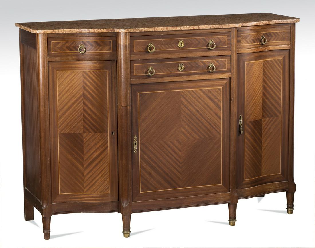 Early 20th c. French marble top walnut buffet, 60"w: French Louis XVI style walnut buffet, late 19th or early 20th century, having a shaped salmon marble top, surmounting a case centering two drawers accented with inlaid rectangular bands and gilt brass