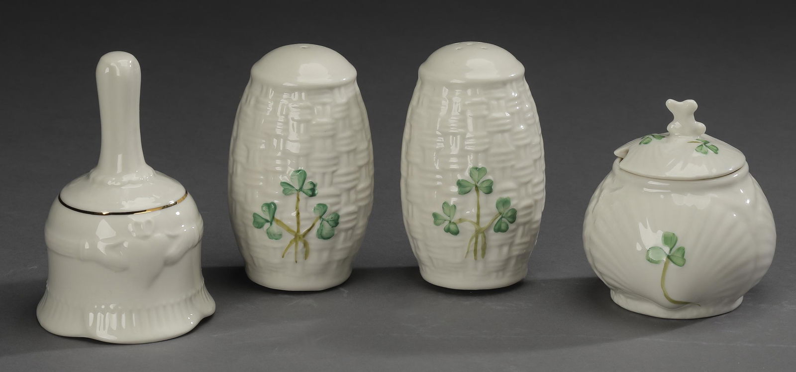 4 pc Belleek porcelain table accessories: Belleek porcelain table accessories, comprising: (1) pair of salt and pepper shakers in the 'Shamrock' pattern, each having a woven texture accented with hand painted shamrocks, marked, 3.5"h; (1) mus