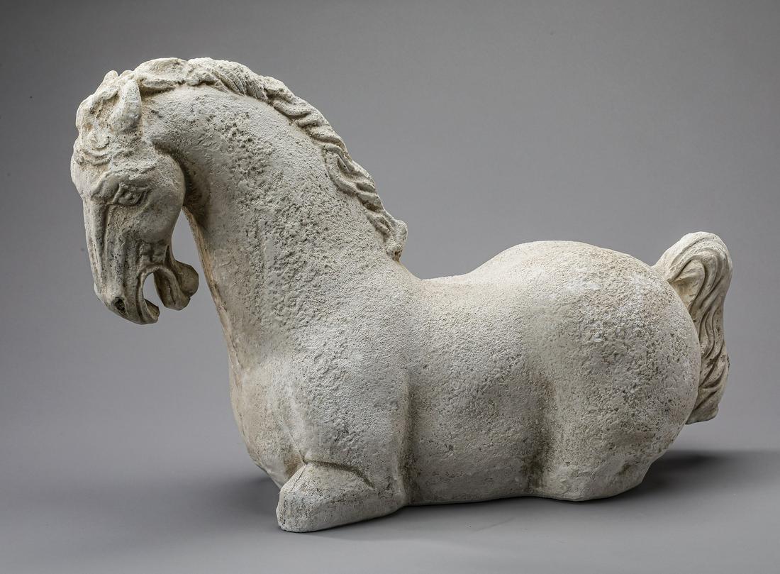Tang style cast stone horse sculpture, 19"l: Tang style cast stone horse sculpture, depicting the emotive face and mane leading to a muscular torso and tail, 12.5"h x 19"l x 6"d.
