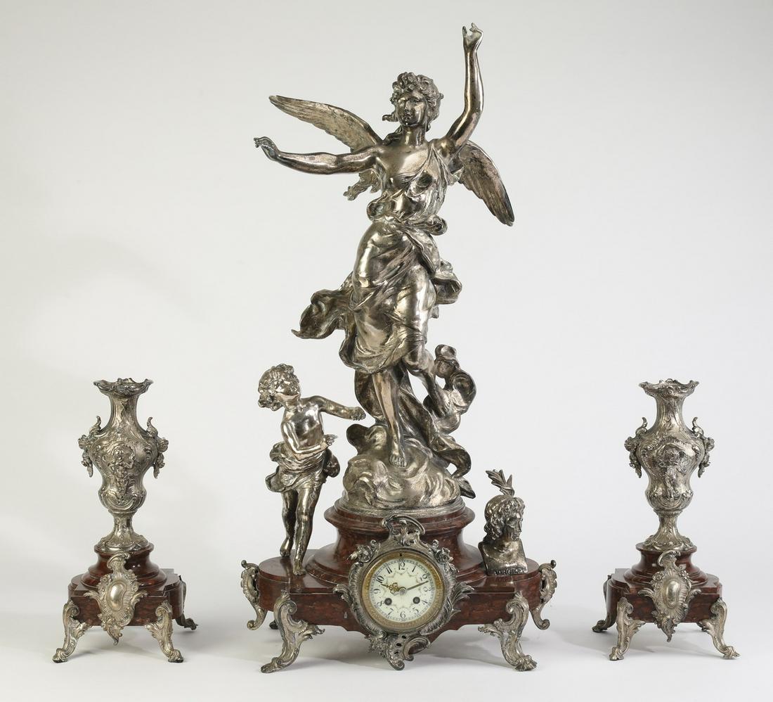 Rococo inspired 3-piece figural clock garniture: Rococo inspired clock garniture, executed in silvered bronze and marble, having a winged goddess with arms outstretched and drapery blowing in the wind, signed 'Hip. Moreau' to the base (after Hippoly